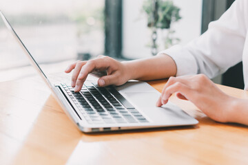Close up of businessman or accountant working on laptop computer for calculate business data,...