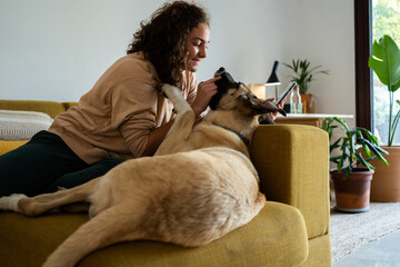 Teen girl playing with dog