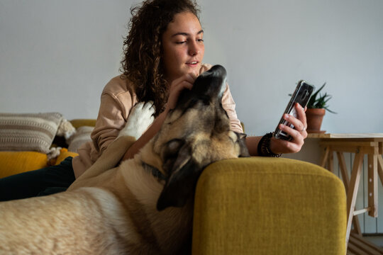 Teenager texting with her dog