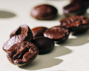 Close up of roasted coffee beans on simple background