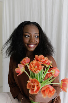 A black woman with fowers