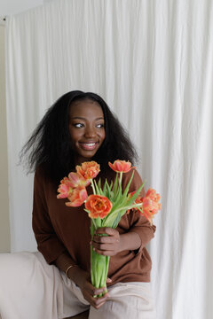 A black woman with fowers