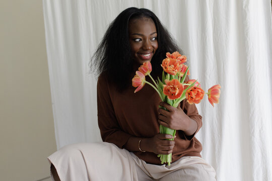 A black woman with fowers