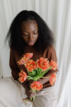 A black woman with fowers