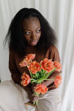 A black woman with fowers
