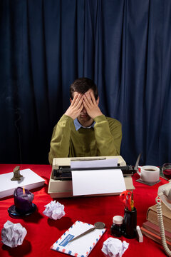 Man at the typewriter desk / Creative blockade