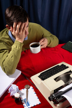 Office worker drinking coffee at office desk