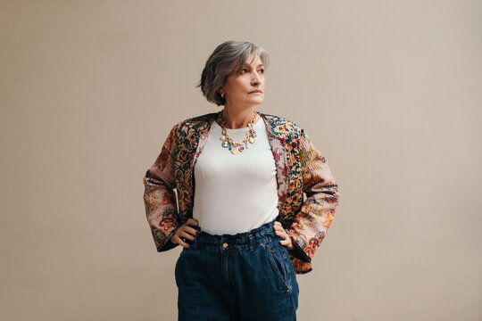 Mature woman fashion portrait on gray background