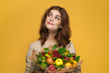 beautiful woman fun posing fruit bouquet vitamins colorful background