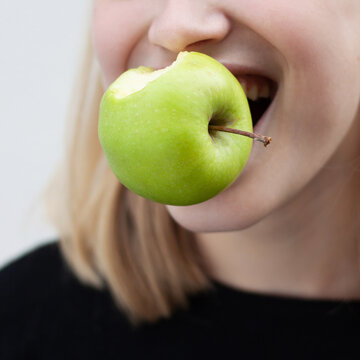 Woman bites an apple