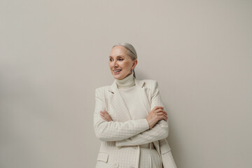 Happy senior woman portrait in white suit 