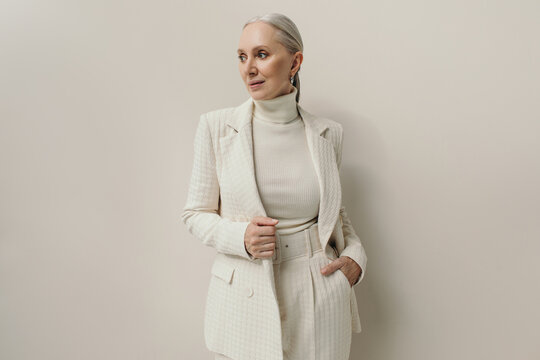 Successful senior woman portrait in white blazer