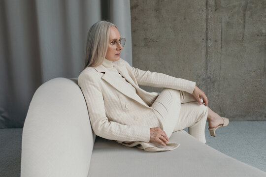 Elegant senior woman in white clothes - Luxury fashion