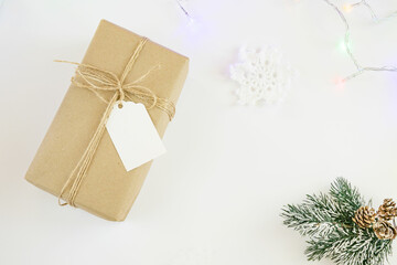Vintage craft gift with rope and blank label isolated on white background. Top view, copy space