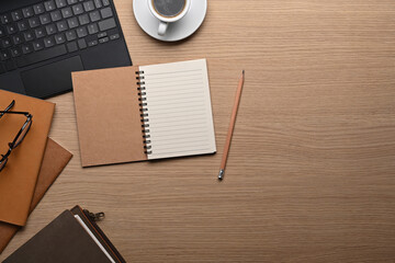 Top view stylish workplace with empty notebook, laptop computer and coffee cup.