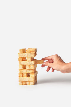 Woman removing cracker block from tower