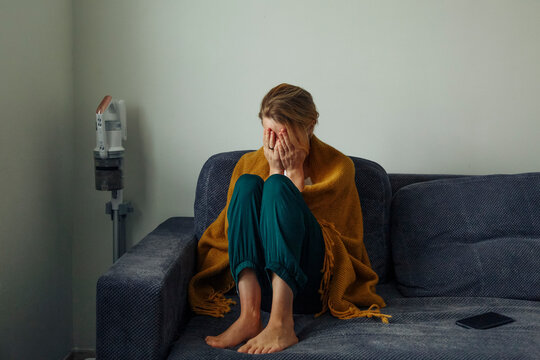 Upset woman sitting on couch