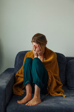 Desperate woman crying on settee
