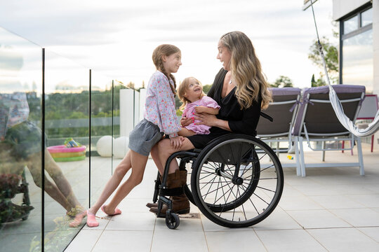Portrait of mother in wheelchair with her daughters