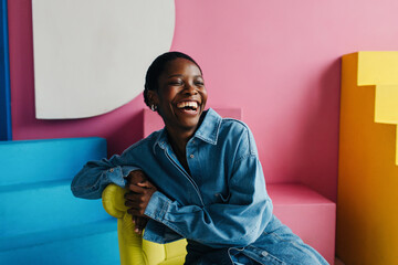 Happy black woman portrait in colorful interior
