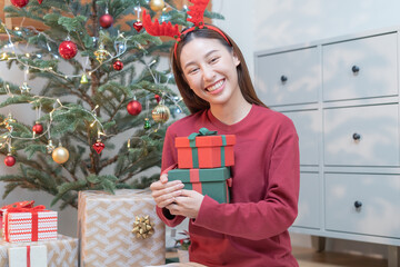 Christmas eve festival season day, surprise asian young woman holding red gift box with green...
