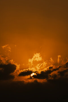 Dark sky with orange sun in evening
