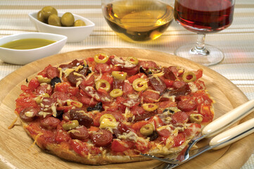 Delicious pizza served on wooden plate isolated 