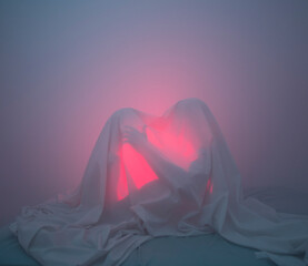 Couple caressing under bed sheet