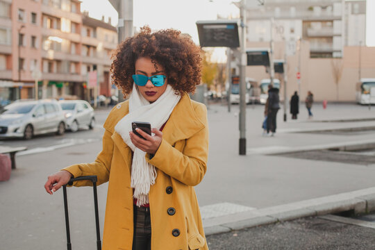  woman using smartphone at bus station
