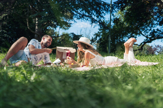 Cheerful couple talking during summer picnic