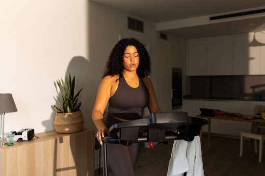 Female walking on a treadmill at home
