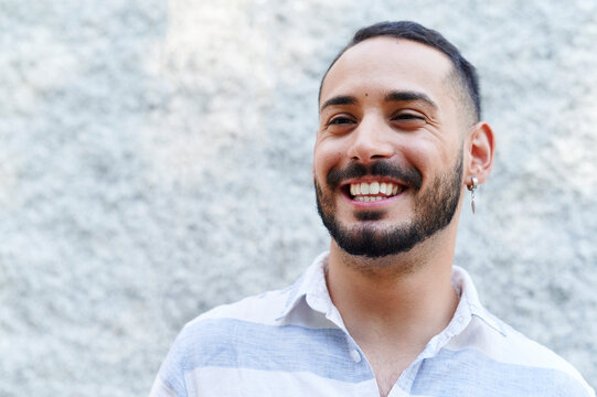 Young man laughing outside