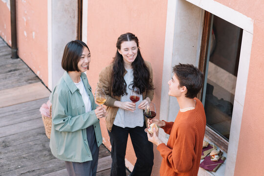 Young Adults Having Aperitif On The Dock In Venice