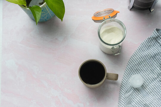 Coffee and collagen powder on table