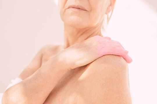 Female naked body part with pink hand