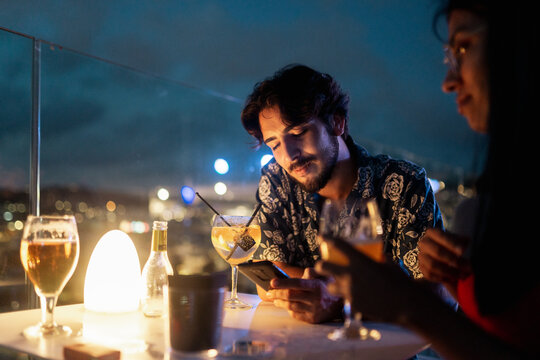 Man checking his phone at a bar