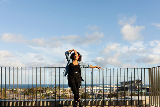 Curvy model standing on rooftop 