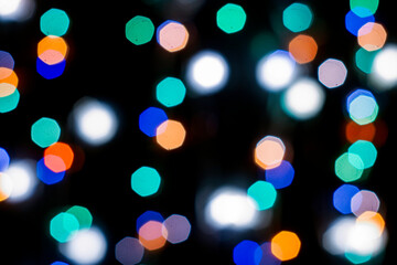 black abstract background with multicolored lights with bokeh in blur