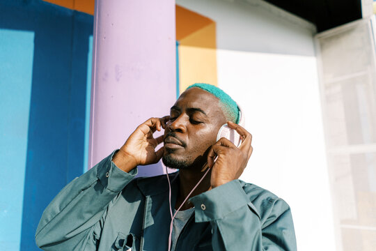 Black man listening to music in headphones