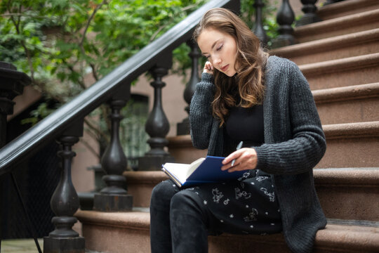 Woman sitting on her stoop and reading