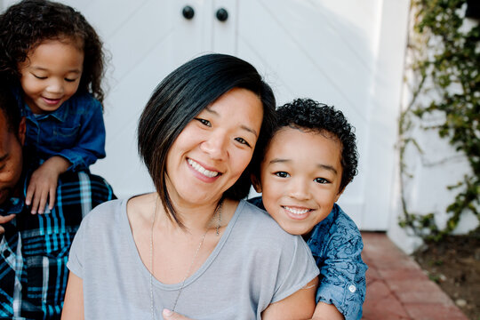 Smiling Asian mom with mixed race son