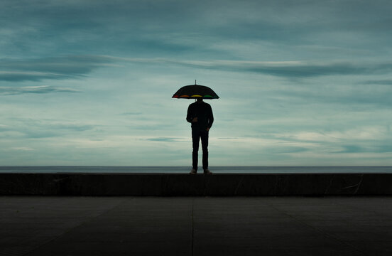 Mysterious man silhouette with umbrella
