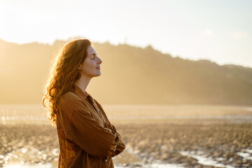 Portrait of serene woman enjoying sunset