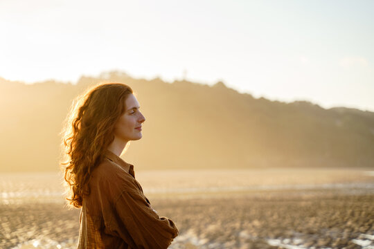 Portrait of serene woman enjoying sunset