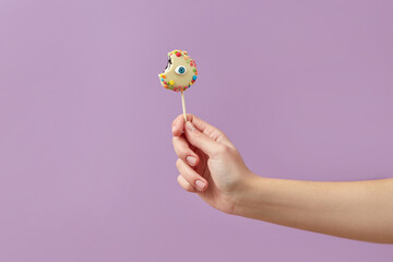 Woman holding eye lollipop