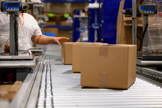 E-Commerce Warehouse with three boxes being shipped 
