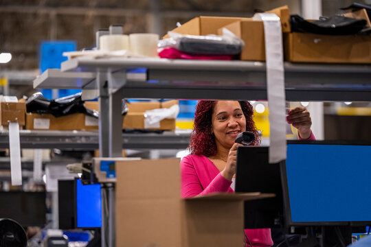 Online shipping warehouse worker with scanner 