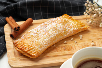 Traditional apple strudel on wooden board, close up