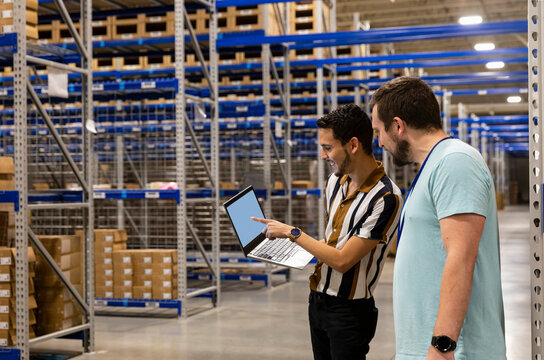 Two Managers having meeting in warehouse workplace   - Powered by Adobe