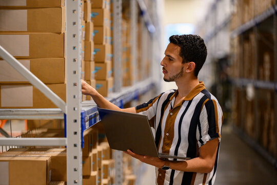 Handsome Hispanic employee with laptop